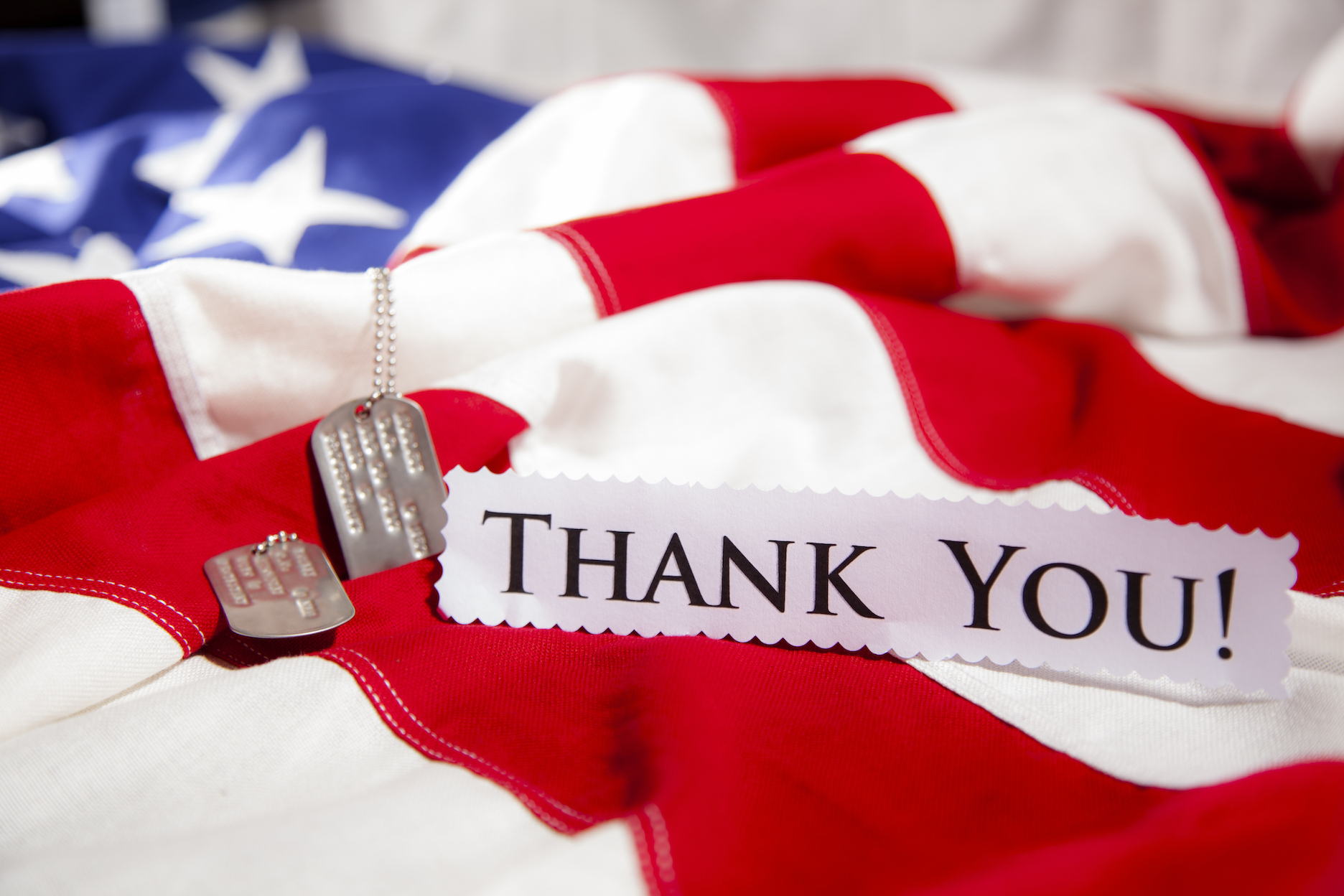 American flag with dog tags an thank you note